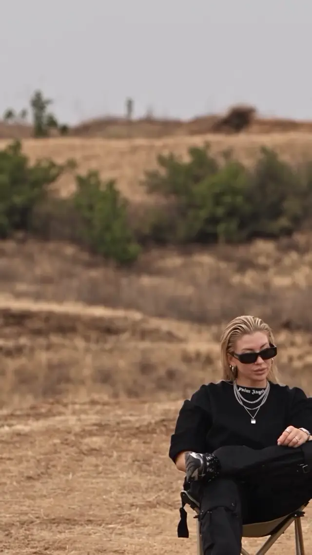 A Black SUV Launches into the Air Behind a Calm, Confident Woman 🚙