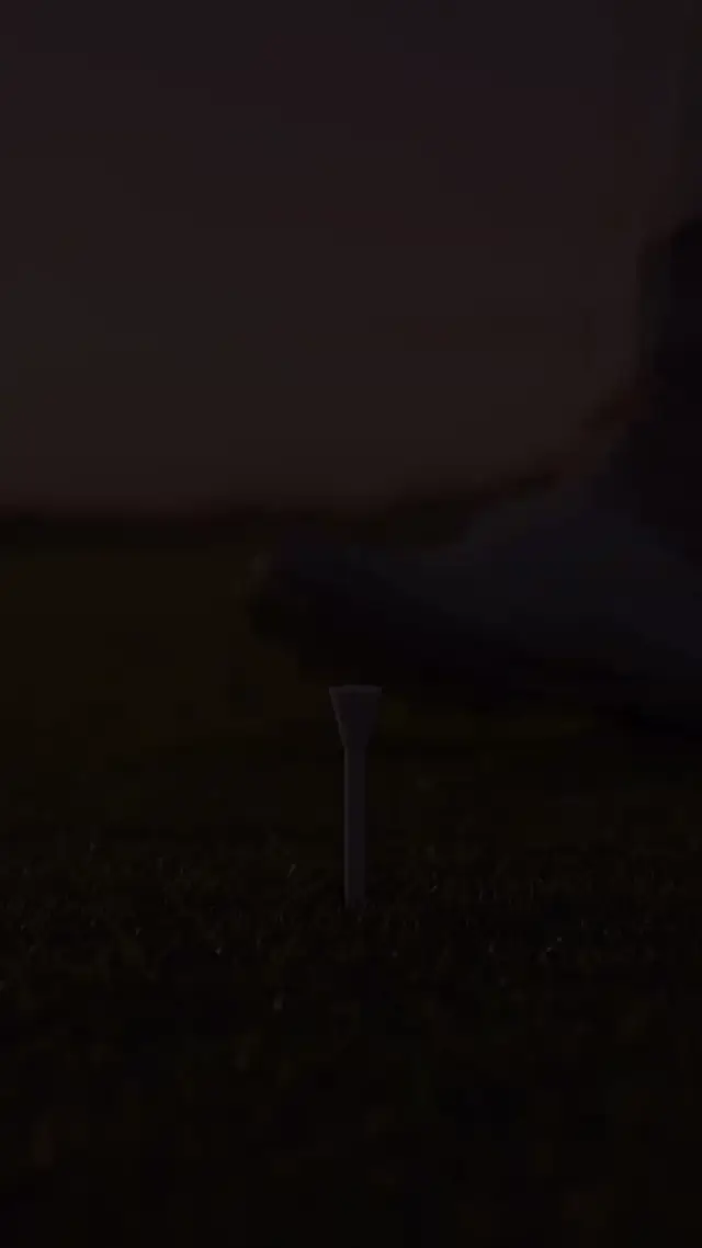 A golfer serves vanilla ice cream into a waffle cone at sunset in slow motion